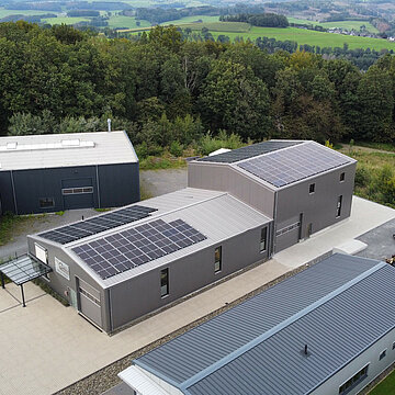 Drohnenaufnahme der moderne Solaranlage auf den Dächern des Firmengebäudes der Tischlerei van der Burg